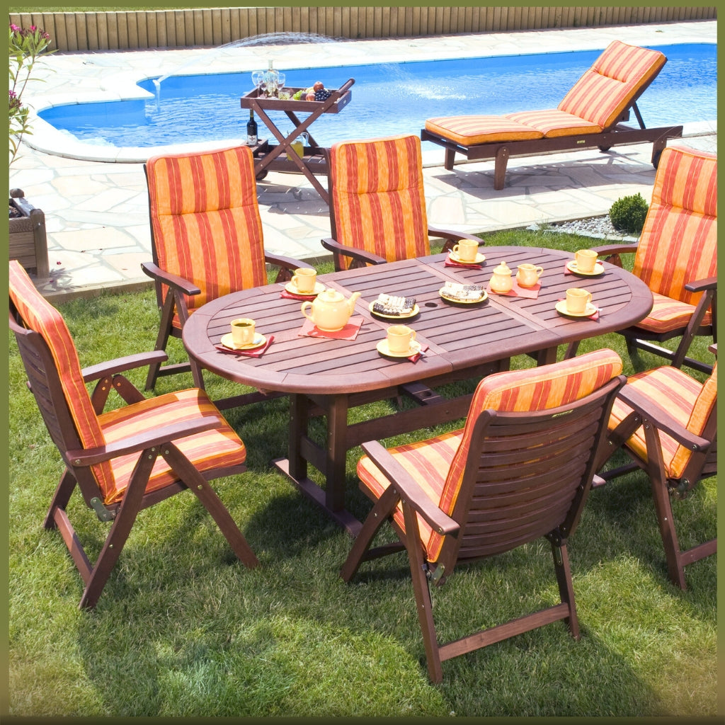 Image of orange striped outdoor patio furniture by pool with brown wood table.