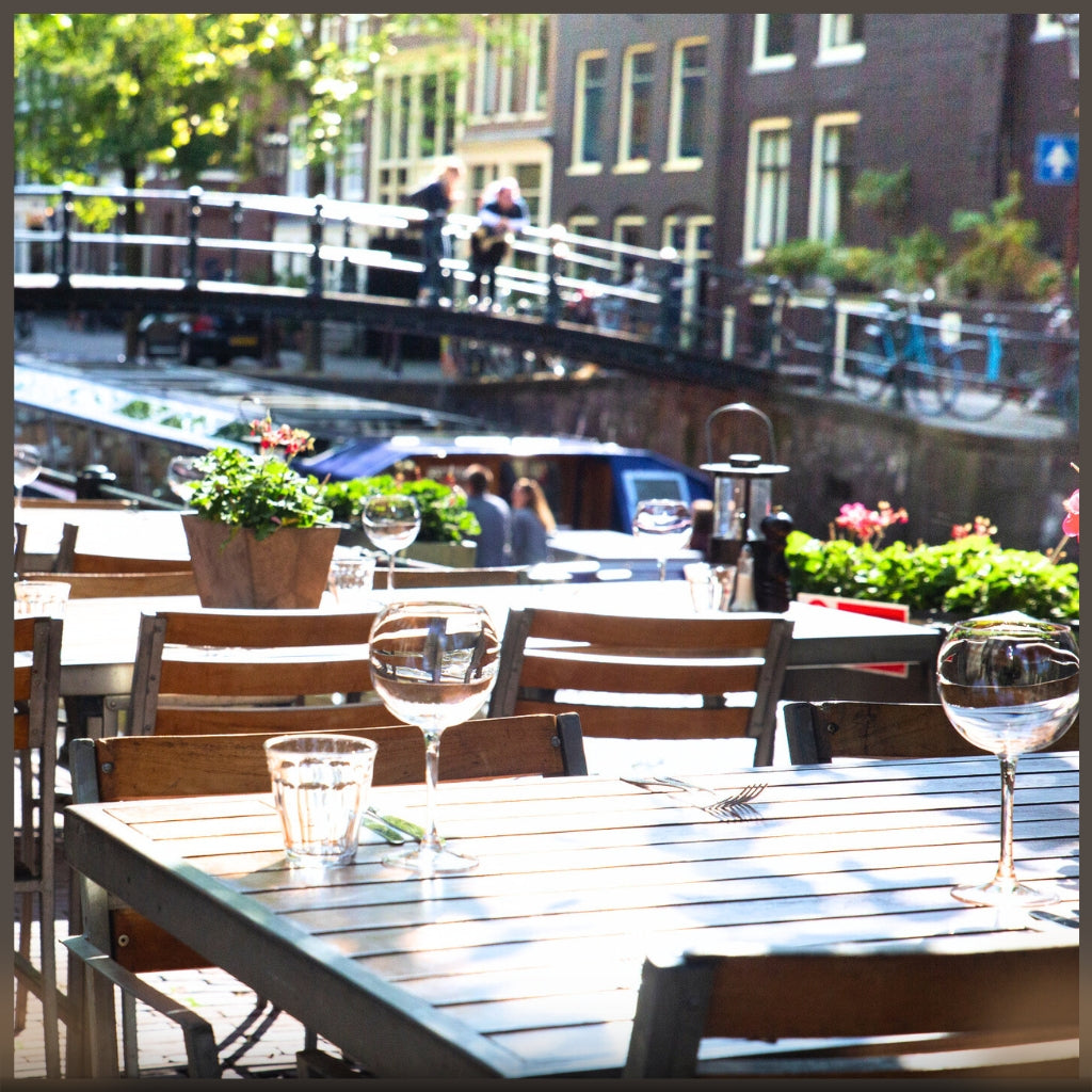 Image of shiny varnished restaurant tables in Amsterdam patio setting