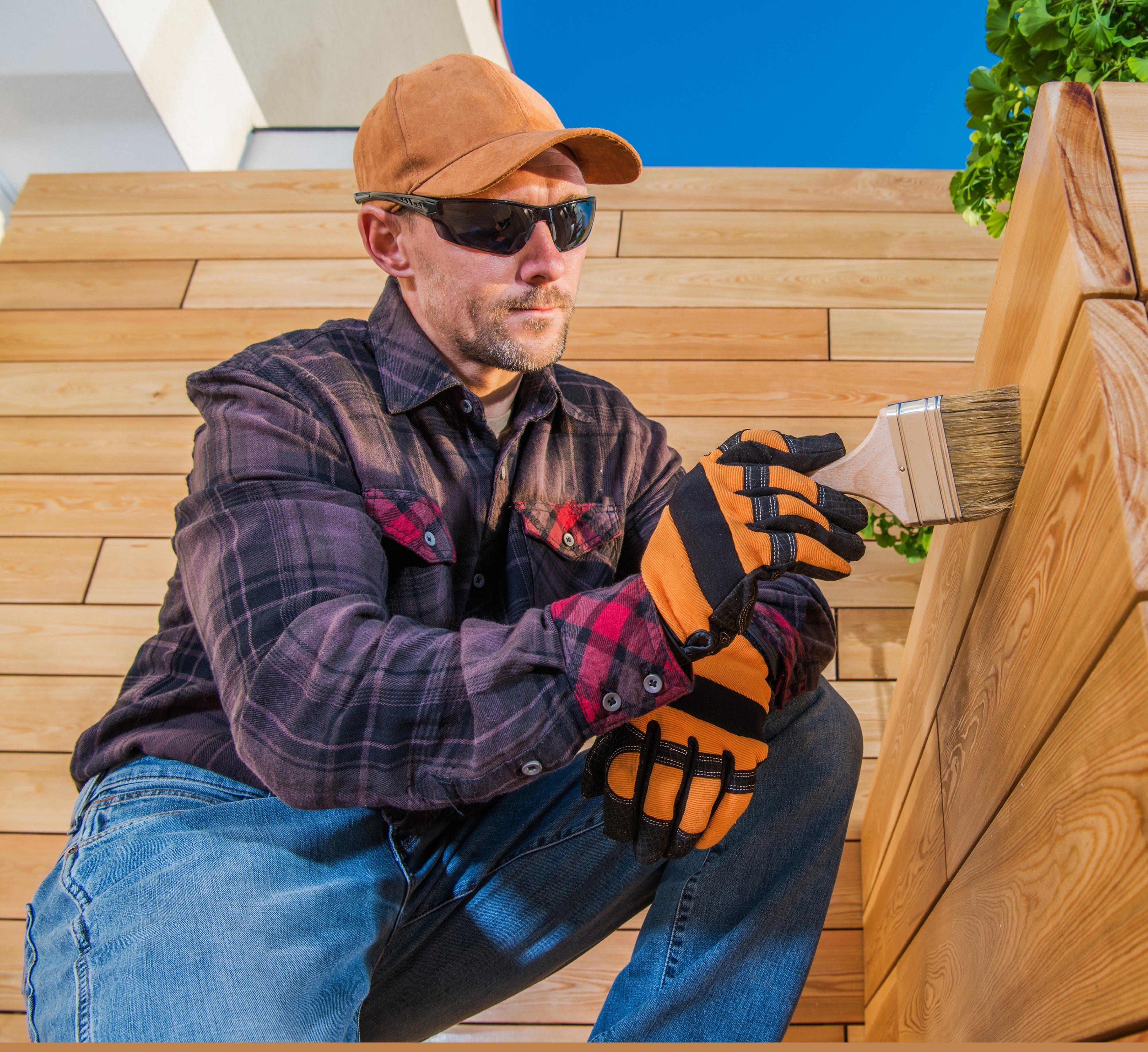 Man applying Polyvine Wood Oil varnish to exterior wood