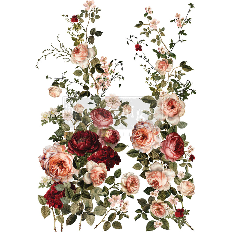 A lush arrangement of pink, red, and peach roses with green leaves on a white background.
