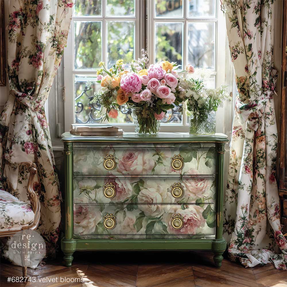 Green vintage dresser decorated with large blush-pink roses, displayed beneath bouquets of flowers between matching floral curtains