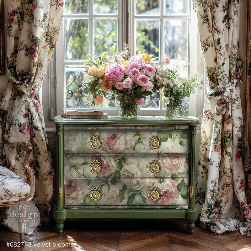 Green vintage dresser decorated with large blush-pink roses, displayed beneath bouquets of flowers between matching floral curtains