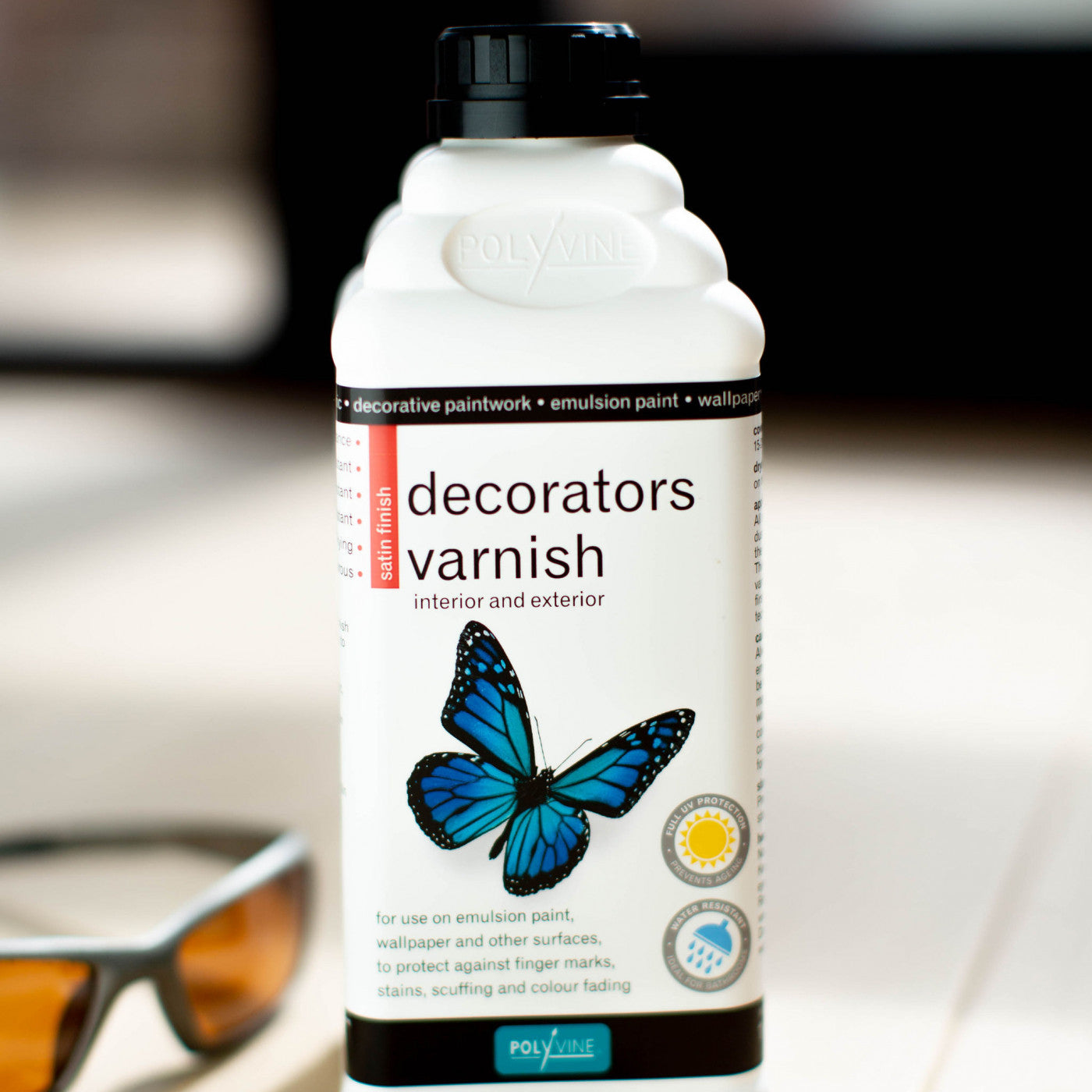 Polyvine Decorators Varnish. 500ml white bottle with blue butterfly and black cap.