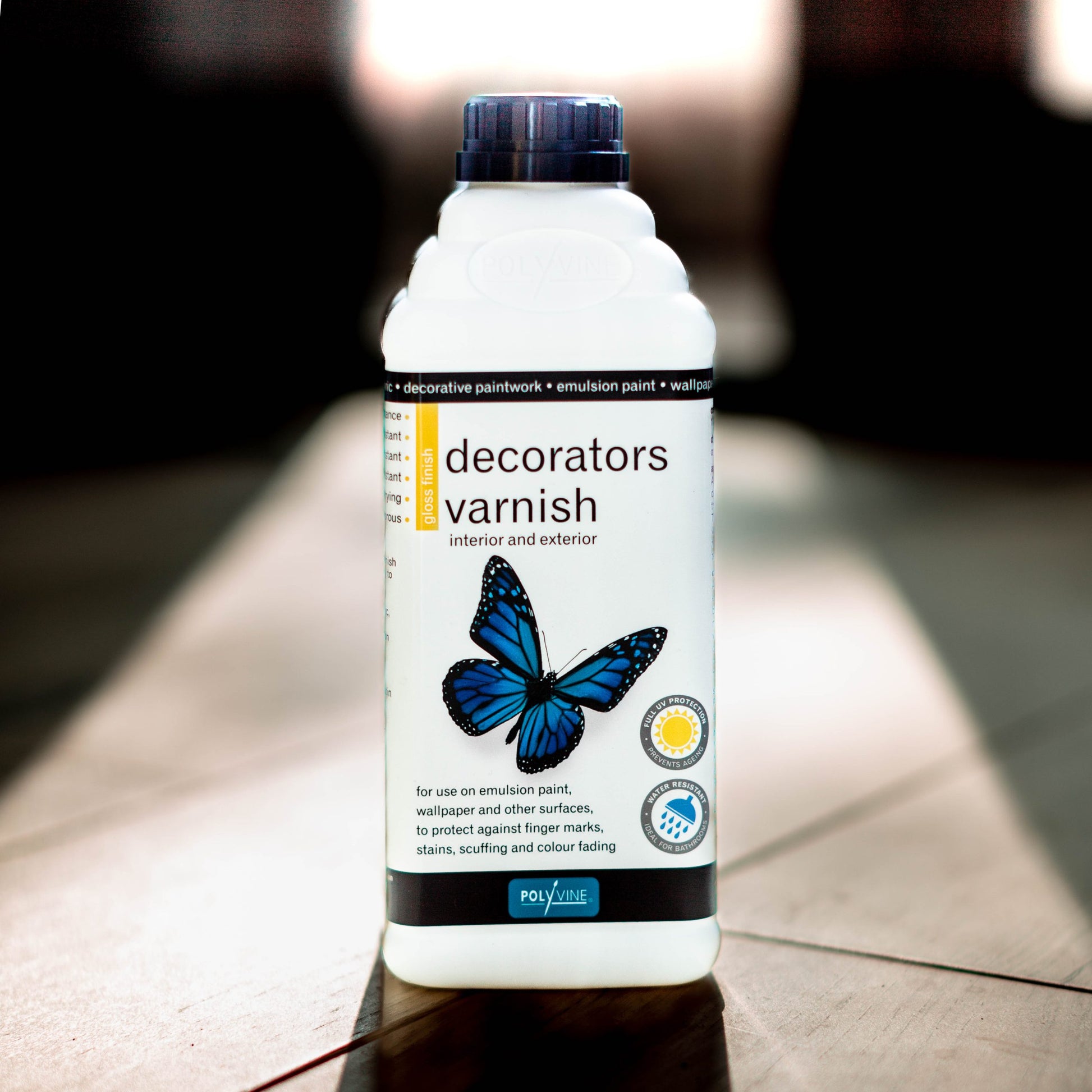 white bottled with black top with black and white label with a blue butterfly of Polyvine Decorators varnish gloss